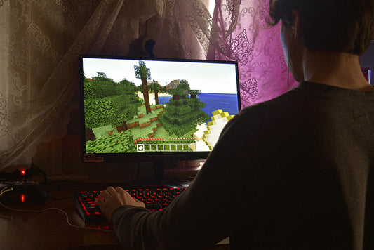 A man enjoying playing games on the desktop computer