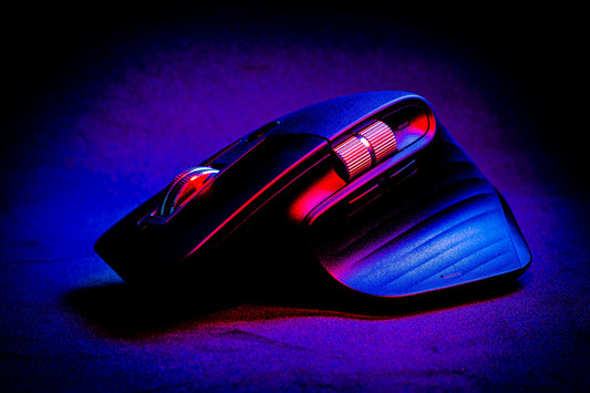 A modern computer mouse under purple lighting