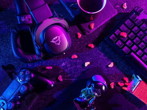  Close up of various gaming accessories on a black surface with snacks