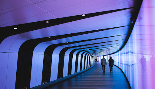 Two men walking down a futuristic hallway