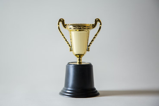 A golden trophy in front of a white background