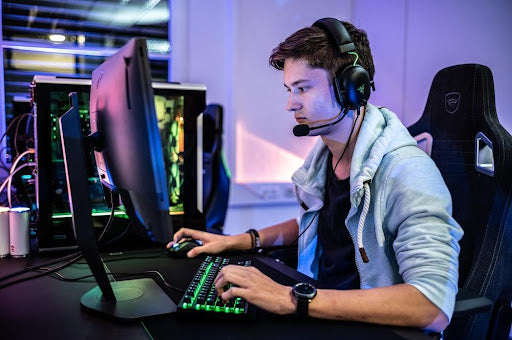 A competitive gamer using an extended gaming mouse pad.